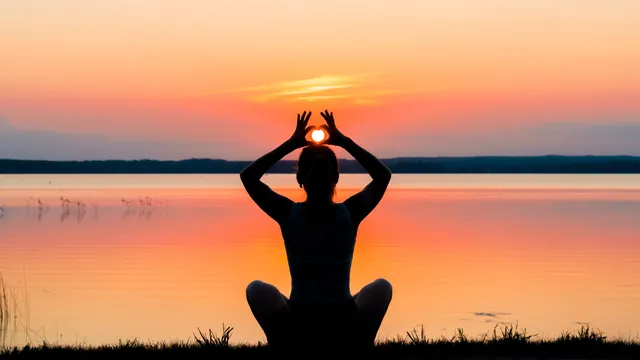 Person in peaceful meditative state surrounded by nature